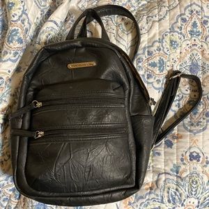 Leather  back pack. One foot long. As new.Holders are adjustable and they zip